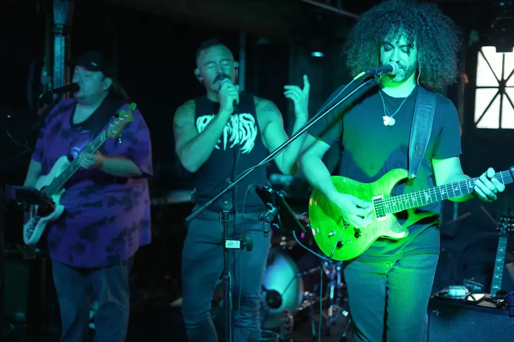 Band playing under green light
